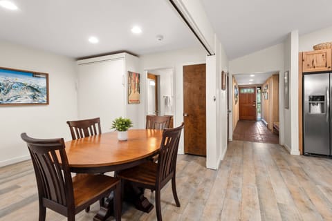 The dining area doubles as a private sleeping den with a queen pull-down murphy bed, full bath and accordion door for privacy.
