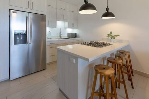 Kitchen with microwave, oven, coffee maker, pots, cutlery, fridge, freezer