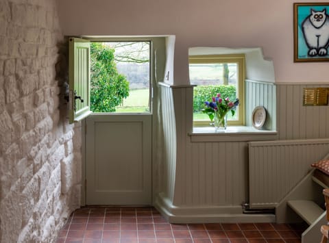 The entrance has a stable door overlooking the garden and hills