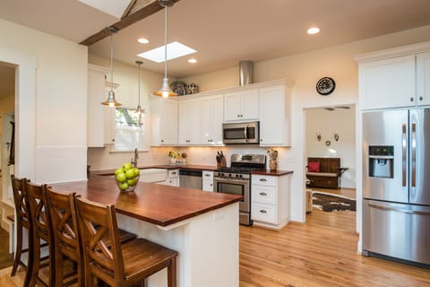 Modern farmhouse style kitchen with open layout, bar seating for 4