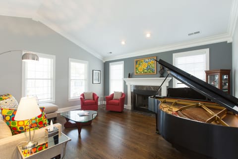 living room with grand piano and gas fireplace