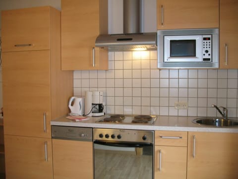 Microwave, oven, dishwasher, dining tables