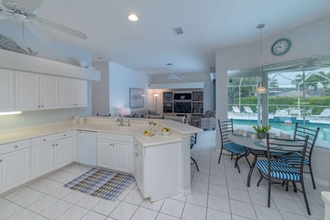 The open kitchen and living area offers plenty of space to cook, eat, or relax on the couch.
