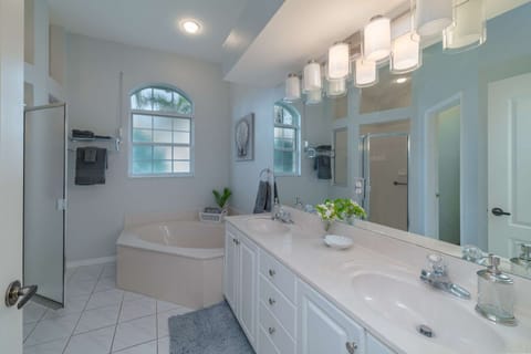 The master bath ensuite is equipped with dual vanities, soaking tub, water closet, step-in shower and plenty of storage.