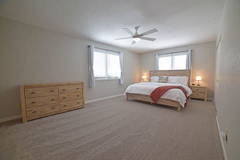 Upper level primary bedroom offers a king-size bed, attached bathroom with two full closets.  A twin floor mattress is located in the side closet of this room.