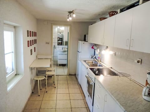 Flooring, Kitchen, Countertop, Kitchen Appliance, Major Appliance, Floor, Furniture, Interior Design, Cabinetry, Room