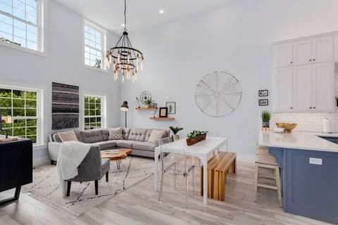 The living room flows perfectly into the kitchen. With plenty of extra seating around the living space, dining table, and bar this is the perfect open space for entertaining.
