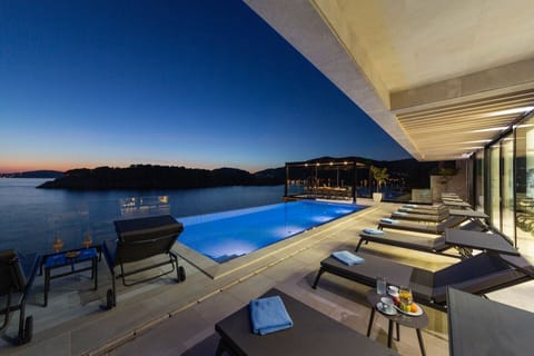 An infinity pool, sun loungers