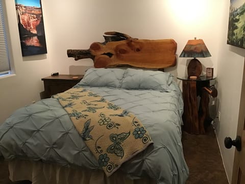 Comfy queen bed with artist made juniper headboard 