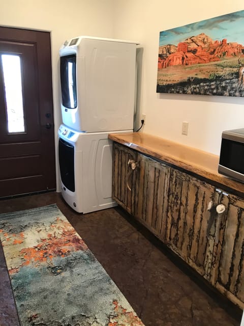 Large pantry, stackable washer dryer, handmade cabinets