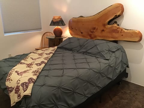 AnoTher comfy queen bed with artist made juniper headboard 