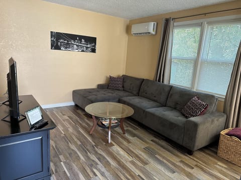 Living room with sectional sofa and mini split 