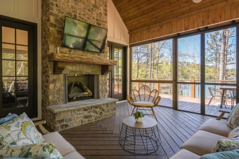 Outdoor screened porch with a gas fireplace