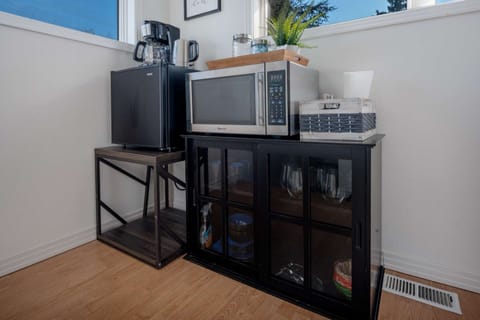 A small kitchenette is provided which includes a mini fridge, microwave, and coffee pot.