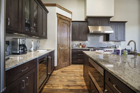 The large kitchen has top of the line appliances and is stocked with everything you may need to cook dinner at home.