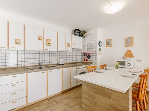 Kitchen, Interior Design, Flooring, Wood, Countertop, Cabinetry, Major Appliance, Furniture, Floor, Kitchen Appliance