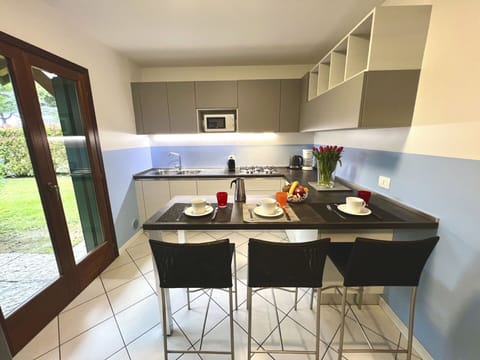 Furniture, Flooring, Interior Design, Wood, Floor, Kitchen, Kitchen Appliance, Room, Countertop, Lighting