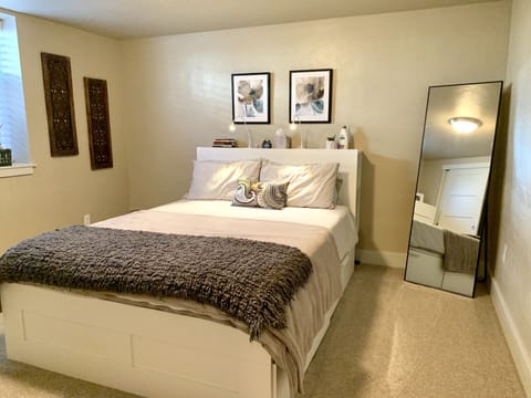 Spacious Bedroom with Queen Bed, large mirror, dresser, closet space, and more!