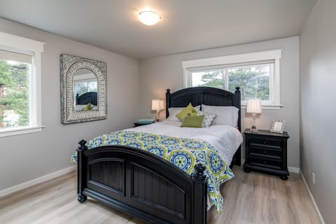 Main floor bedroom with queen size bed and mountain views.