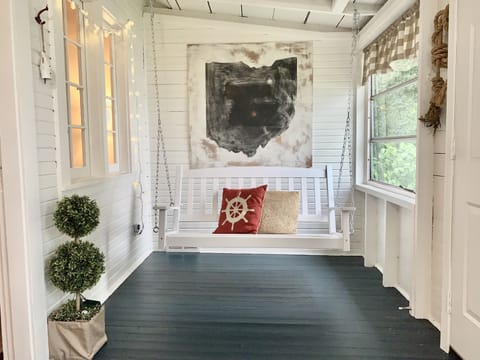air conditioned front porch with swing and breakfast table