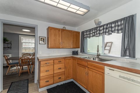 Fully functional kitchen, stocked with pots, pans, & dishes.