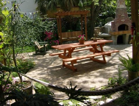 View of yard from deck, gardens, grill, pizza oven