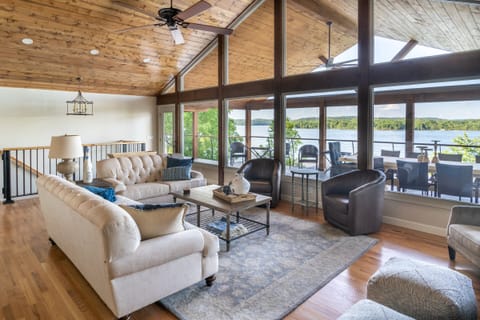 Open living room that walks out to 1200 sq ft patio that is right over the water