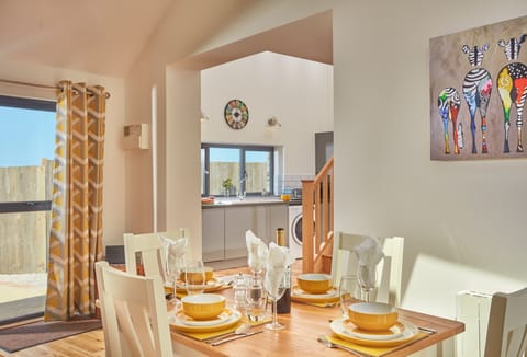Ground floor: Dining area with table and seating for four