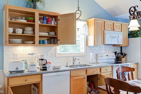 Stocked cabinets including toaster, blender, waffle maker, mixer & coffee pot