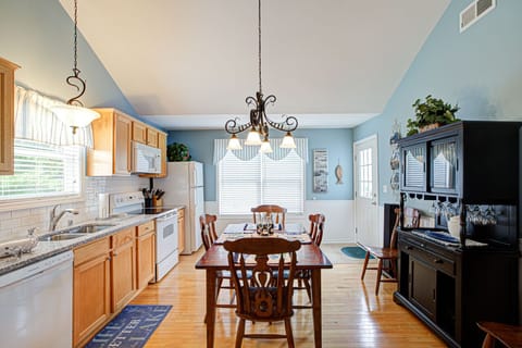 Kitchen featuring granite countertops, tiled backsplash, wine bar & seats 6.