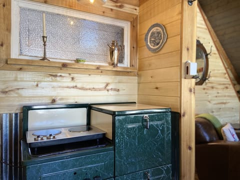 Antique 1940’s stove for storage and as a platform for a modern 2 burner cooktop