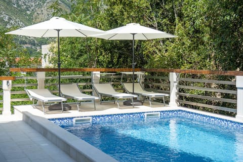 A heated pool, sun loungers