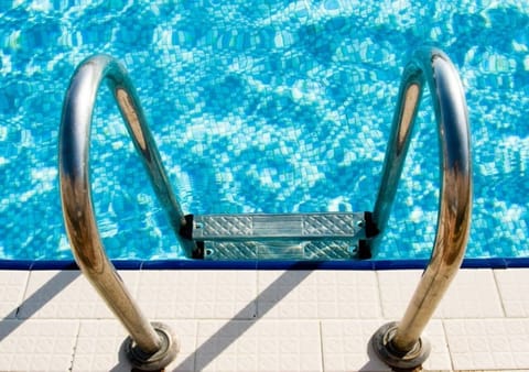 A heated pool, sun loungers