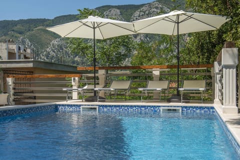 A heated pool, sun loungers