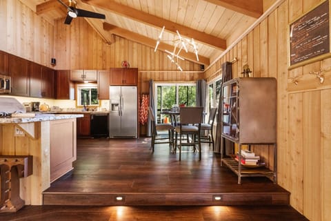 The kitchen is fully equipped and features both a dining table - The kitchen is fully equipped and features both a dining table and a breakfast bar for additional seating.