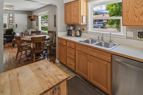 Cozy dining area beside the kitchen with a round table for six and a convenient coffee maker nearby.
