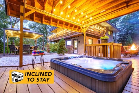 Enjoy the hot tub during all seasons as the rooftop will shelter you from rain. Also notice the balcony that wraps half way around the house - a perfect spot to enjoy the natural surroundings.