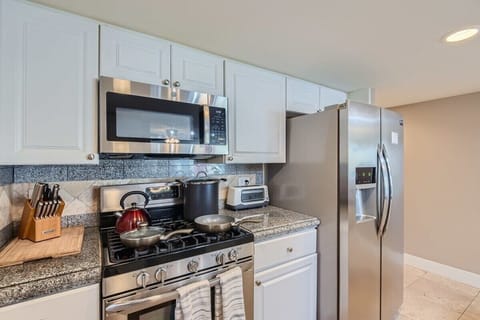 Enjoy the full kitchen with coffee, creamers, mixers, spices, refrigerator, oven, microwave, stove, pots, pans, cooking supplies, cutlery, cups, plates, bowls, utensils, small appliances, and many essentials!
