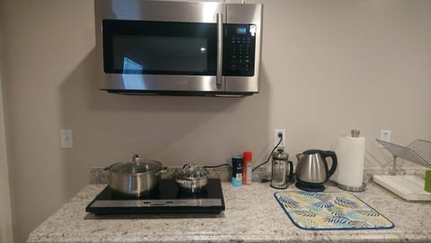 Microwave, cookware/dishes/utensils, dining tables