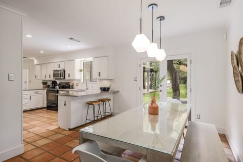 Enjoy views of the lush backyard from the small dining table.