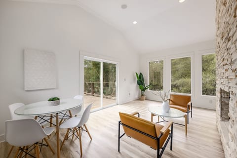 Another seating area + table leading to the second floor deck and yard.