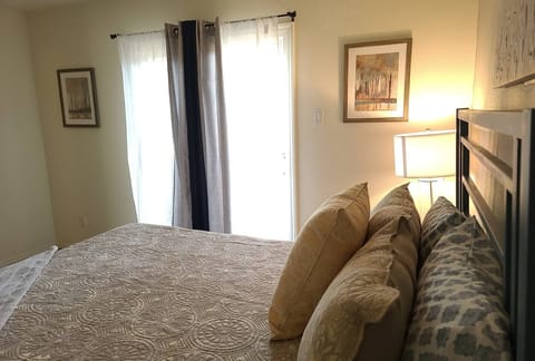 Bedroom includes a sliding glass do with access to a fenced in backyard area