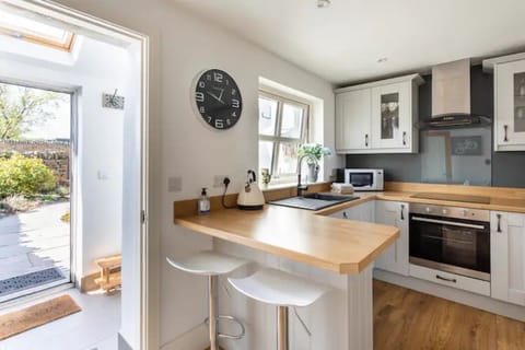 Breakfast bar, door to entrance porch and sunny patio area.