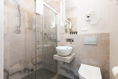 The modern bathroom includes a refreshing shower and essential amenities.