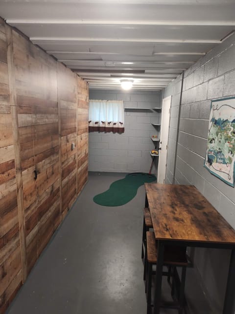 lower level golf putting green. washer, dryer, half bathroom also located here.