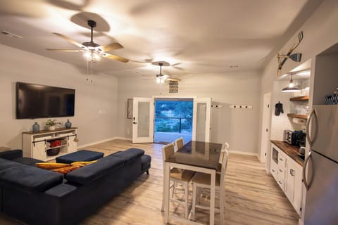 Living room with TV, couch and dining table