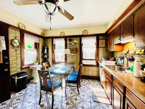 Large sunny tile kitchen with stainless sink, dishwasher, double door fridge