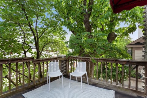 Our home's private balcony with string lights & patio seating, covered by gorgeous old trees - balcony overlooks downtown Fayetteville as our place is on the second floor.