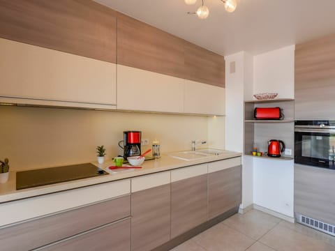 Cabinetry, Countertop, Property, Kitchen Stove, Kitchen Appliance, Building, Wood, Lighting, Orange, Kitchen