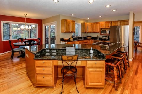 The extra-large island with bar stools and the cozy dinette seating area add to the charm of this amazing kitchen.